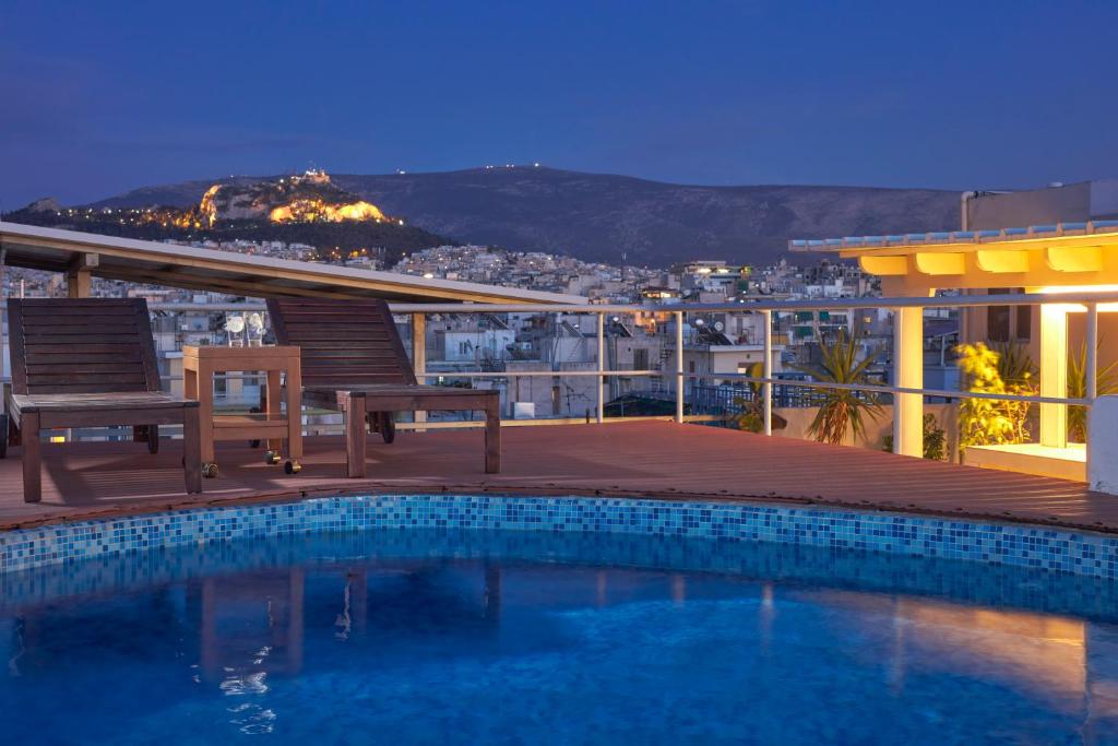 a swimming pool on the roof of a building at Candia Hotel in Athens