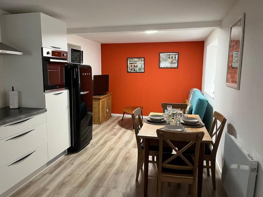 a kitchen and dining room with a table and a refrigerator at Chez Mat - 4 pers - Proche Obernai in Bernardswiller