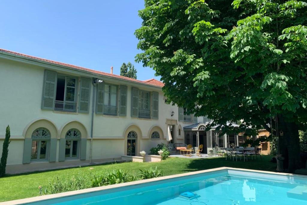 a house with a swimming pool in front of it at Les Gargouilles - House with crazy charm heated pool and garden in Caluire-et-Cuire