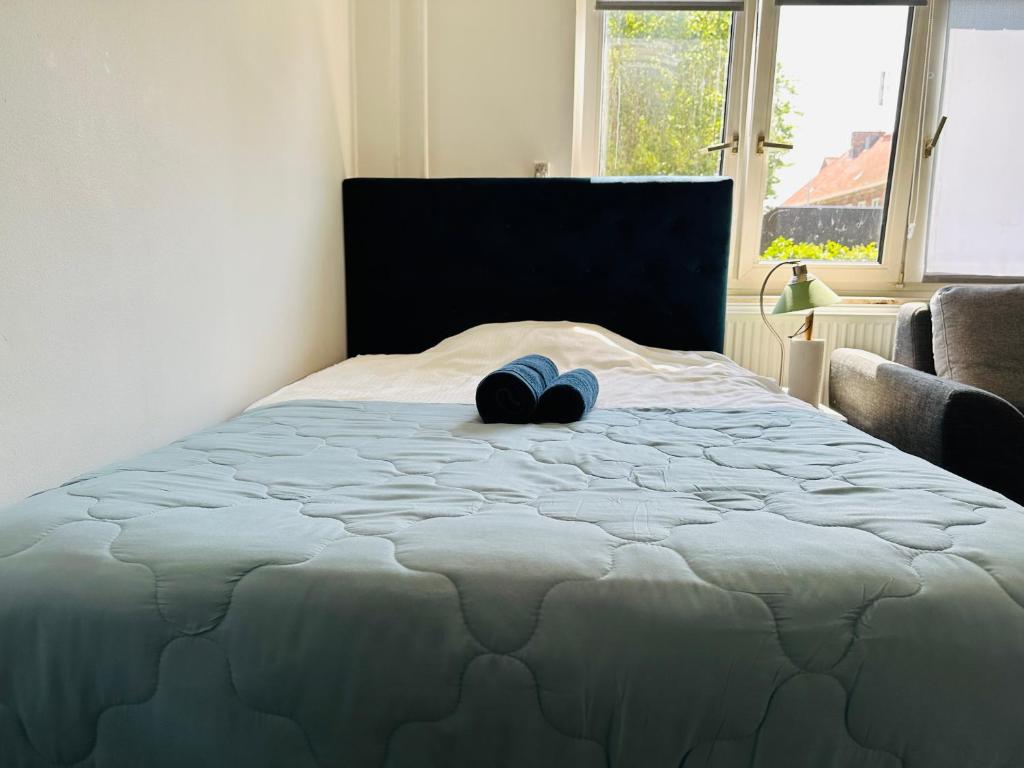 a bed with a blue heart pillow on it at One bedroom apartment in Copenhagen