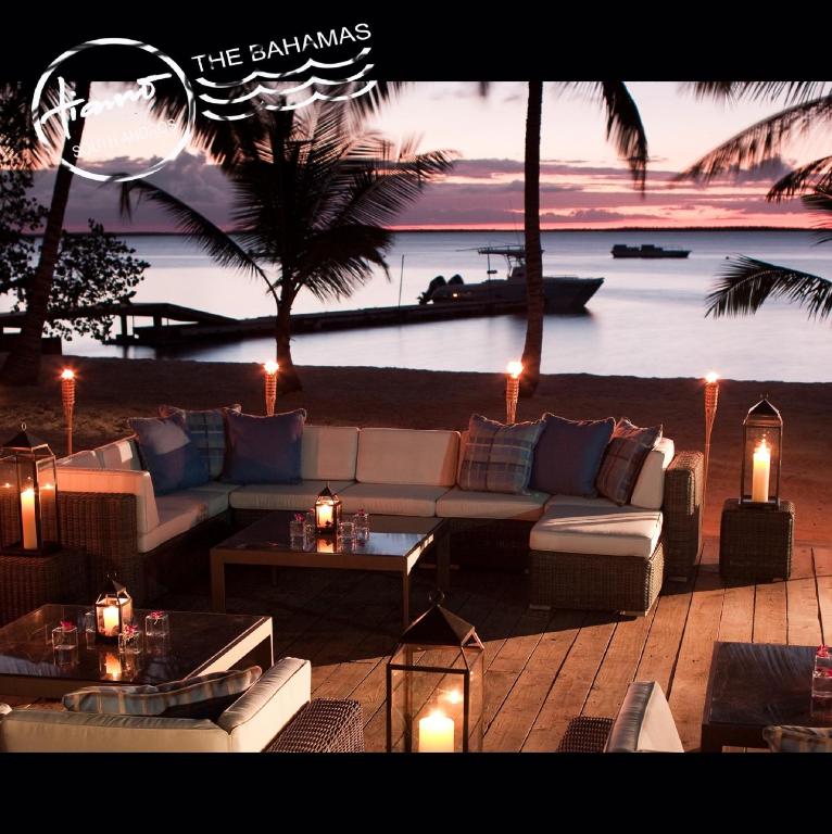 a living room with a couch and tables and a beach at Tiamo Resort in Kemps Bay