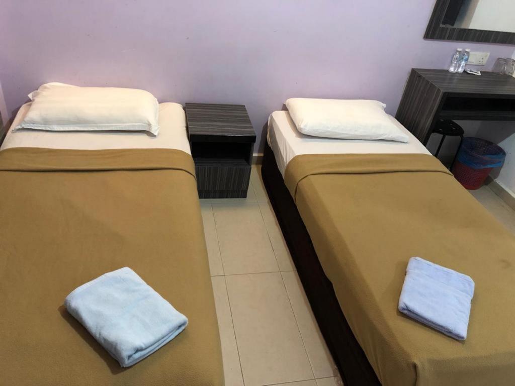 Postel nebo postele na pokoji v ubytování Al Huda Hotel