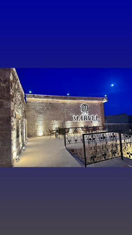 a building with a sign on the side of it at Marvel Hotel Mardin in Mardin