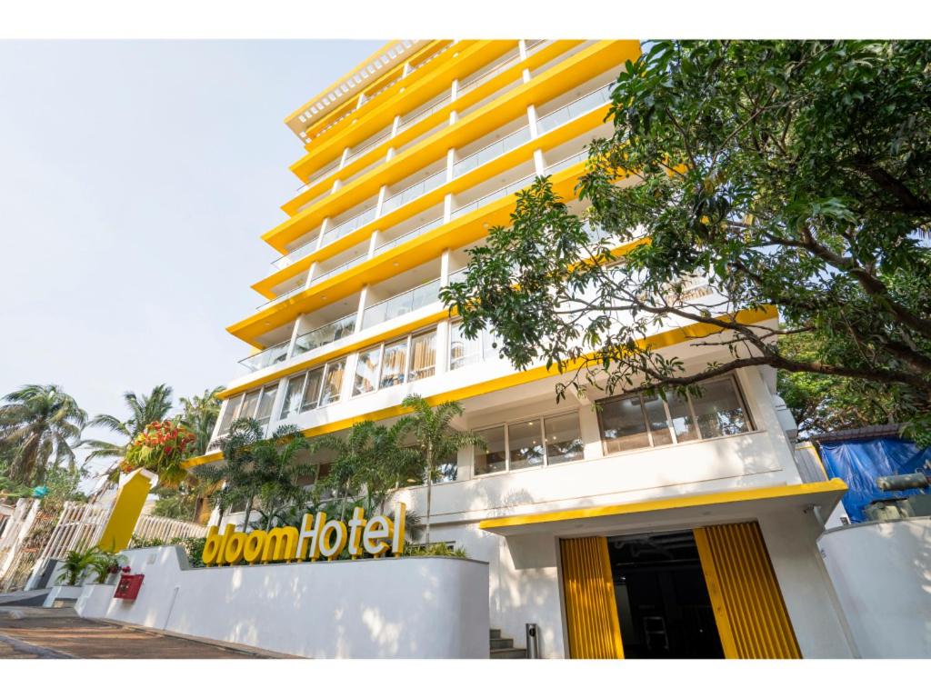 a building with a brown hotel sign in front of it at Bloom Hotel - Dona Paula in Panaji
