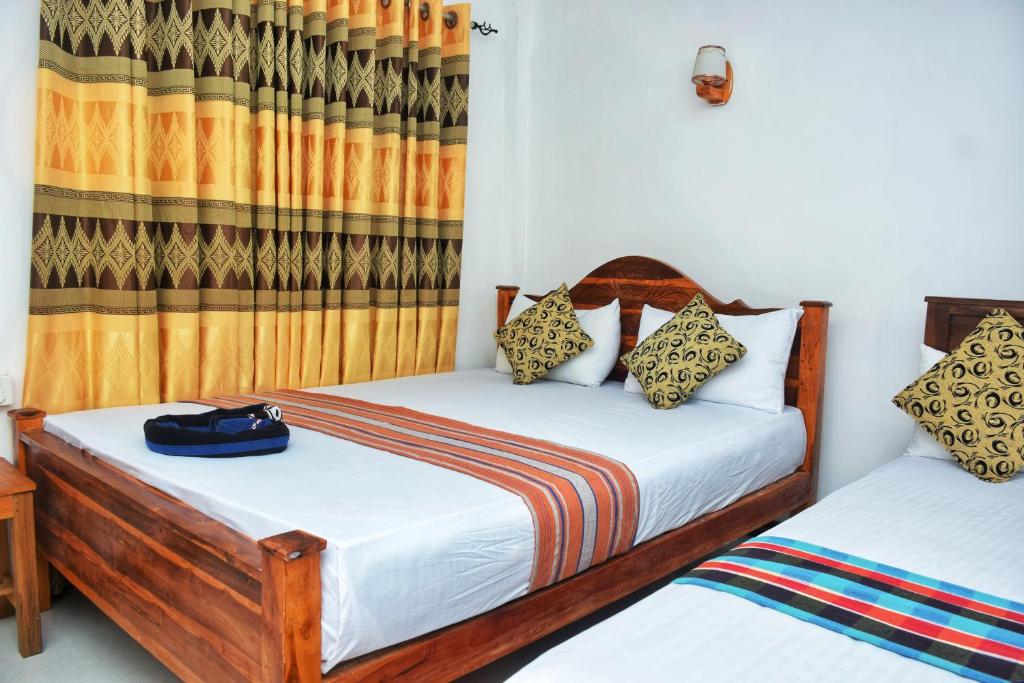 una camera con due letti e una tenda di Passion Ray Villa & Tree Hut a Sigiriya