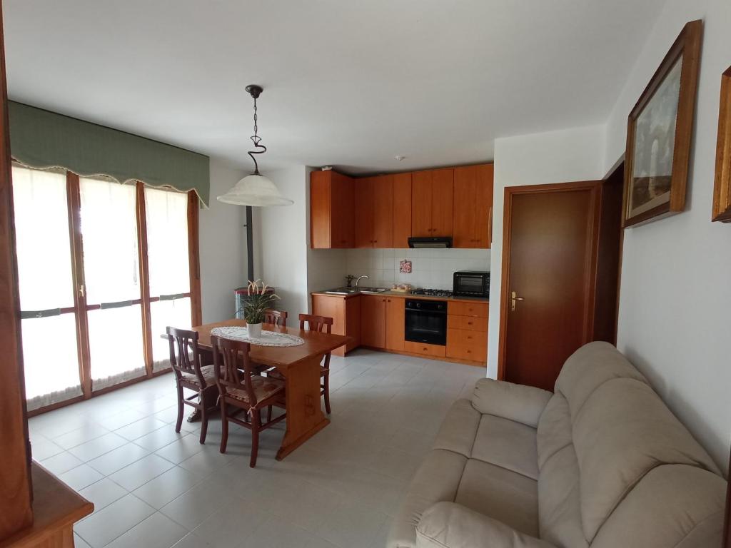 a living room and kitchen with a couch and a table at Relax in Maremma in Il Bagno