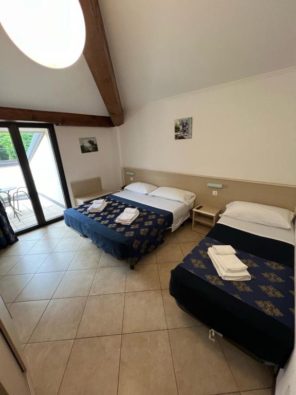 Postel nebo postele na pokoji v ubytování Hotel Merloni