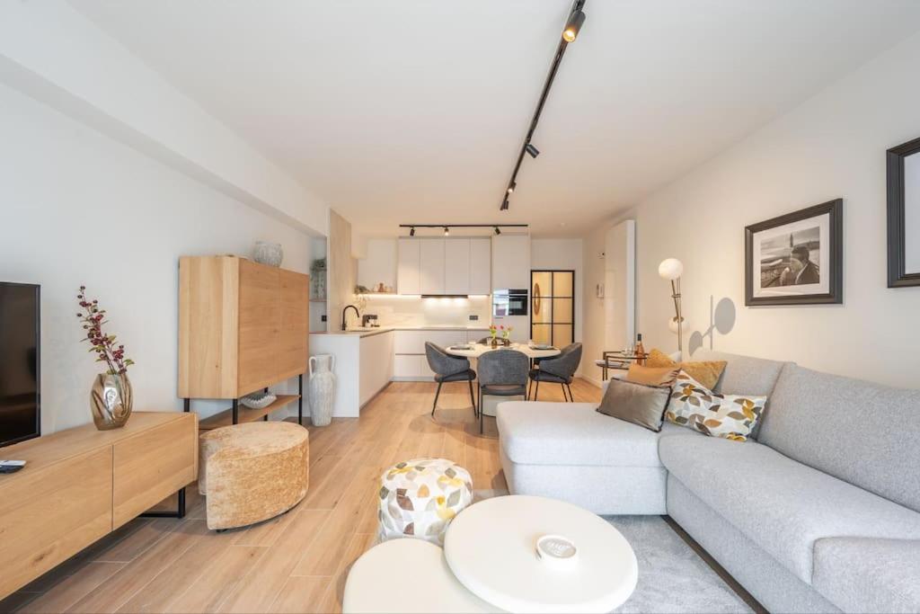 a living room with a couch and a table at gezellig en trendy appartement knokke in Knokke-Heist