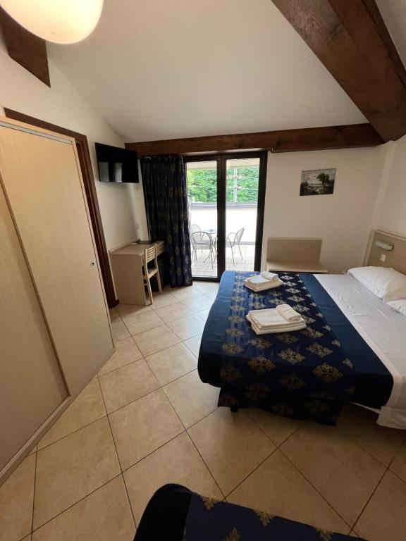 Postel nebo postele na pokoji v ubytování Hotel Merloni