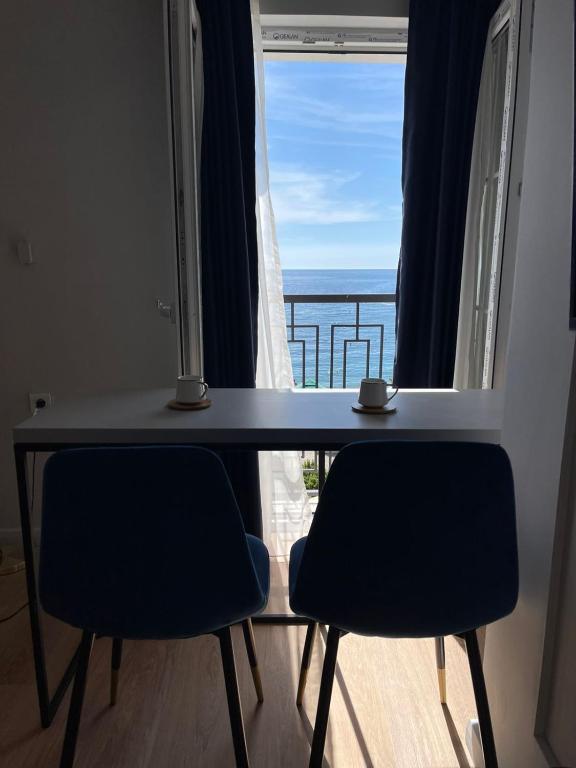 un tavolo con due sedie e una vista sull'oceano di Lungomare Apartments a Petrovac na Moru
