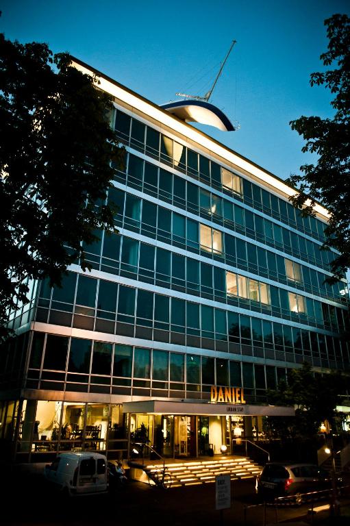 a large glass building with a dana sign on it at Hotel Daniel Vienna - Smart Lifestyle Near City Centre in Vienna