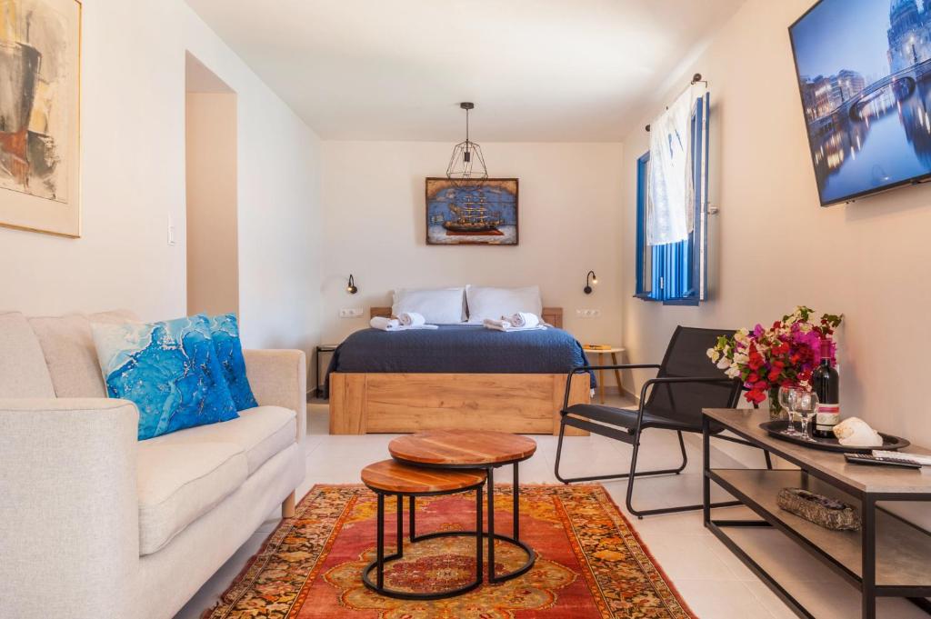 a living room with a bed and a couch at Porphyra Studio in Halki
