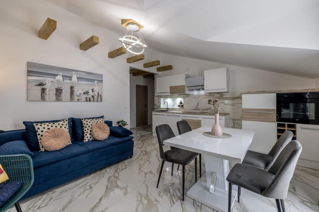 sala de estar con sofá azul y mesa blanca en Royal Blue Marine, en Vodice