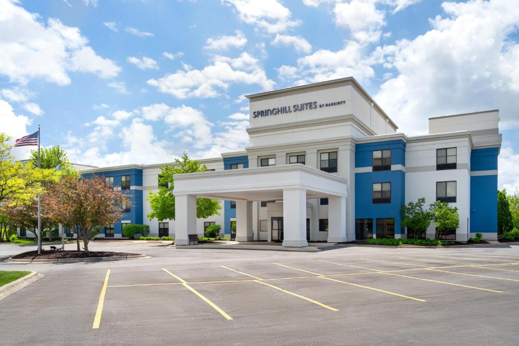 an office building with a parking lot at SpringHill Suites by Marriott Chicago Bolingbrook in Bolingbrook