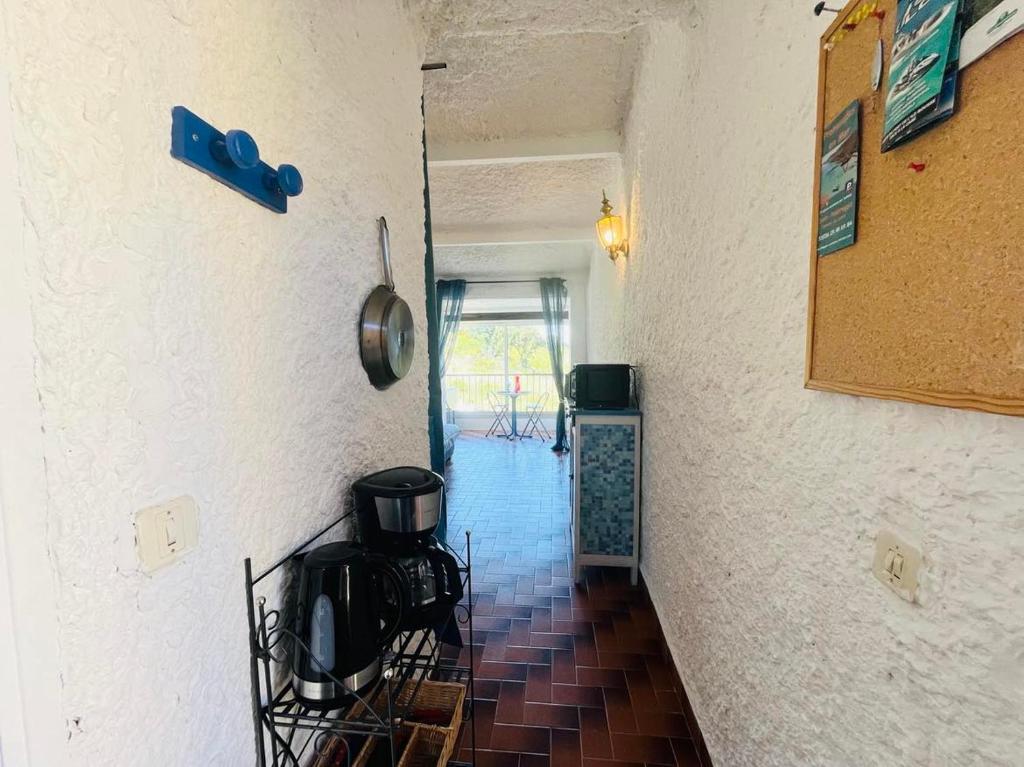 a hallway leading to a room with a kitchen at Studio Cocody 49 LUMIO in Lumio