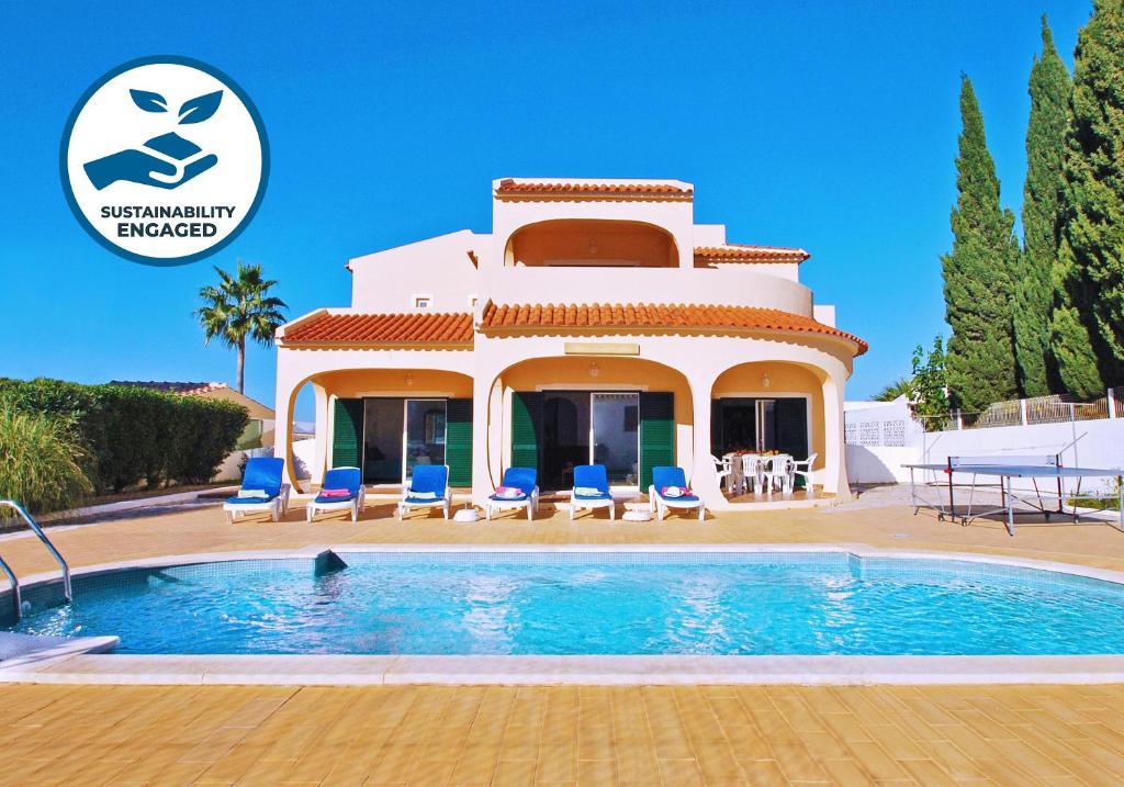a villa with a swimming pool in front of a house at Villa La Romana by Algarve Vacation in Albufeira