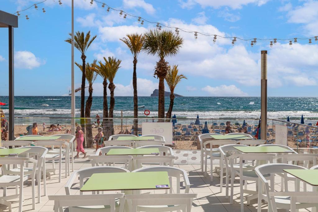a group of tables and chairs on the beach at Hotel Brisa in Benidorm