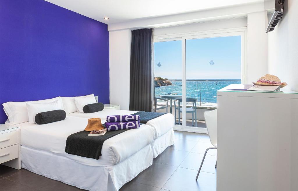 a hotel room with a bed and a view of the ocean at Hotel Brisa in Benidorm