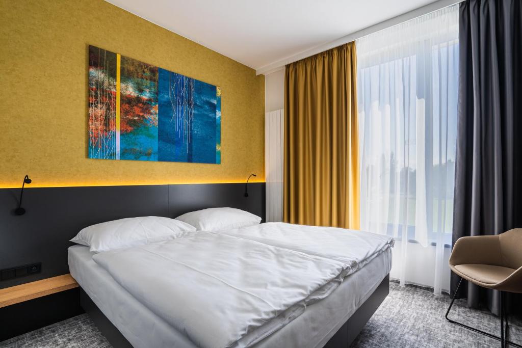 Postel nebo postele na pokoji v ubytování EA Congress Hotel Aldis