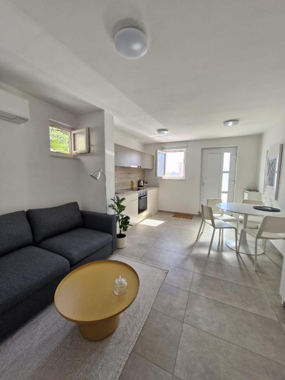 a living room with a couch and a table at Luni in Zadar