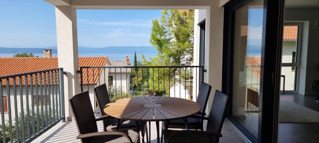 a table and chairs on a balcony with a view at Seabreeze Luxury Apartments in Njivice