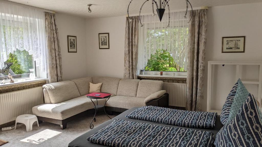 a living room with a couch and a table at Pension Haus Erika in Cuxhaven