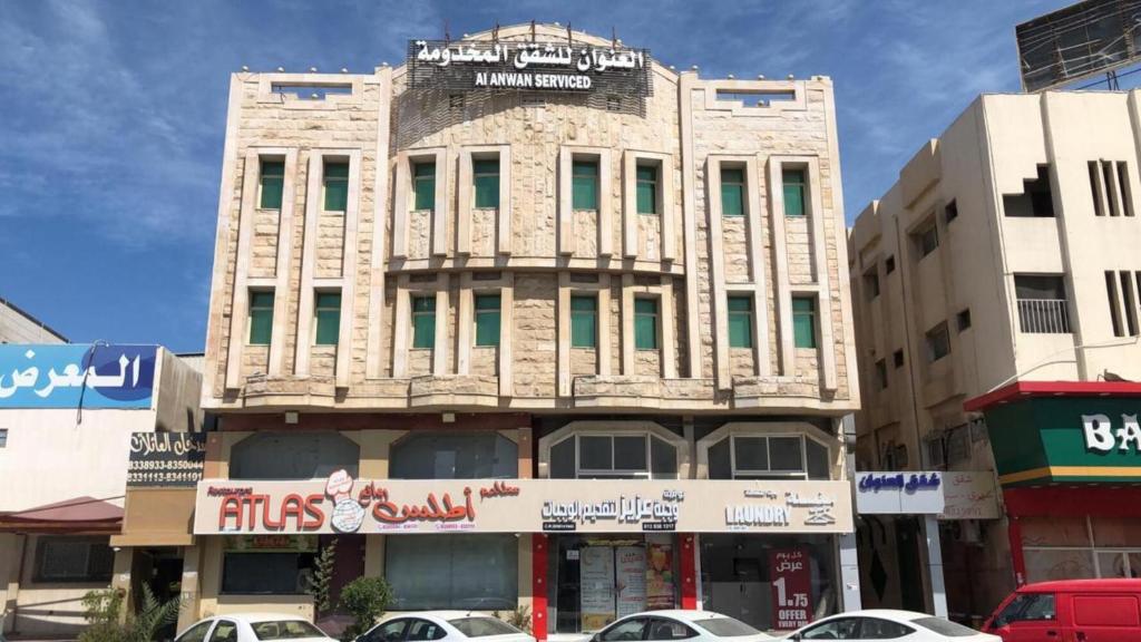 a building on a city street with cars parked in front at العنوان للوحدات المخدومة ALanwaan of the units served in Dammam
