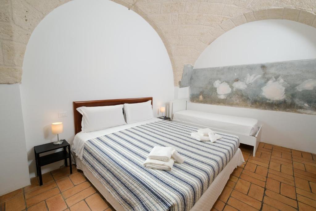 a bedroom with a bed with towels on it at Masseria Borgo Santuri in Ostuni