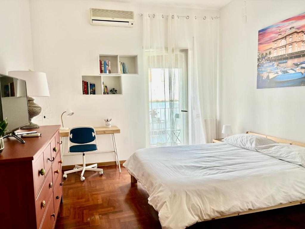 a bedroom with a bed and a desk and a chair at Only in Bari in Bari