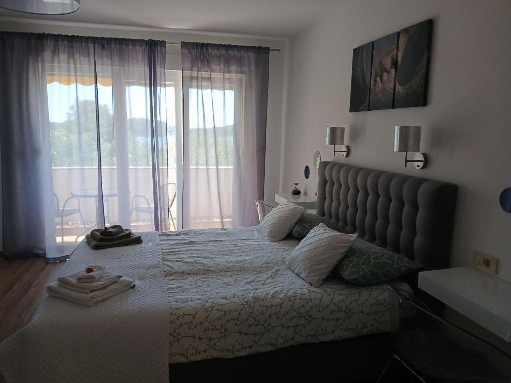 Postel nebo postele na pokoji v ubytování Riviera Rooms and Apartments