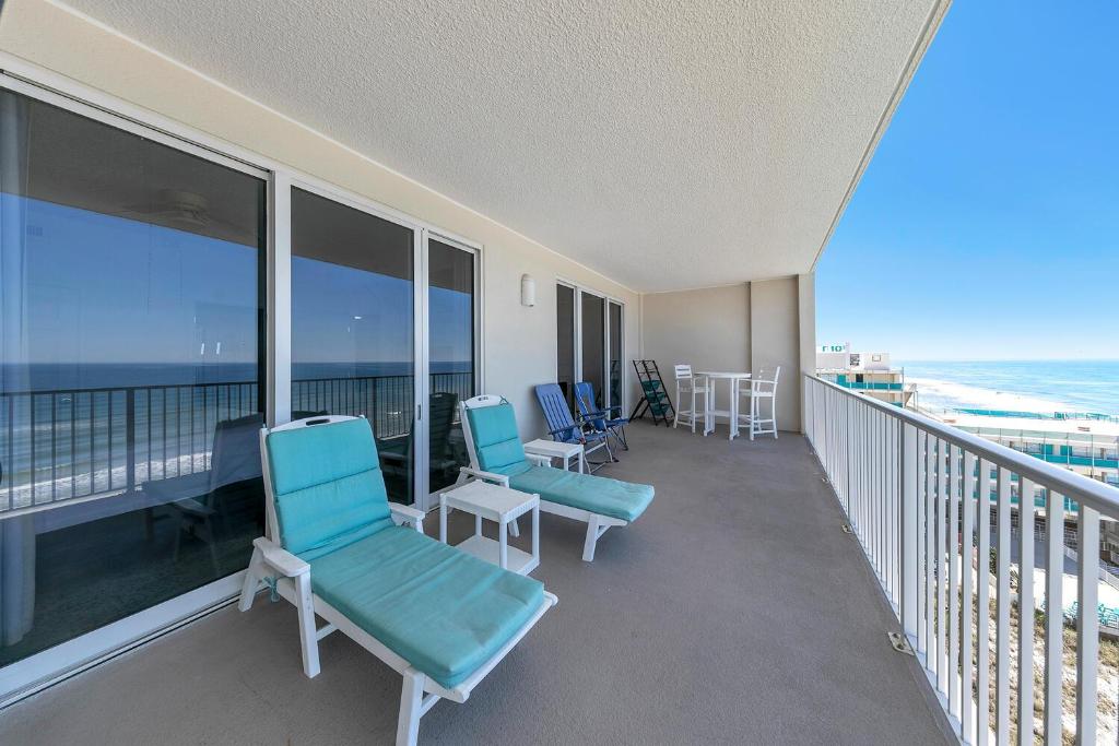 a balcony with chairs and a view of the ocean at Ocean Reef 904 by Emerald Coast Retreats in Panama City Beach