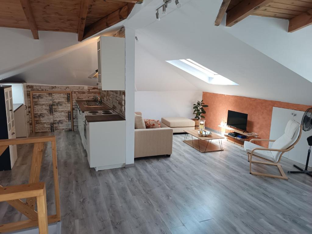 a large living room with a kitchen and a living room at Airport Loft , paiania in Paianía