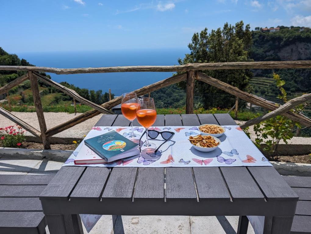 a picnic table with wine glasses and food on it at Louis House ad Agerola per Amalfi Positano Pompei in Agerola