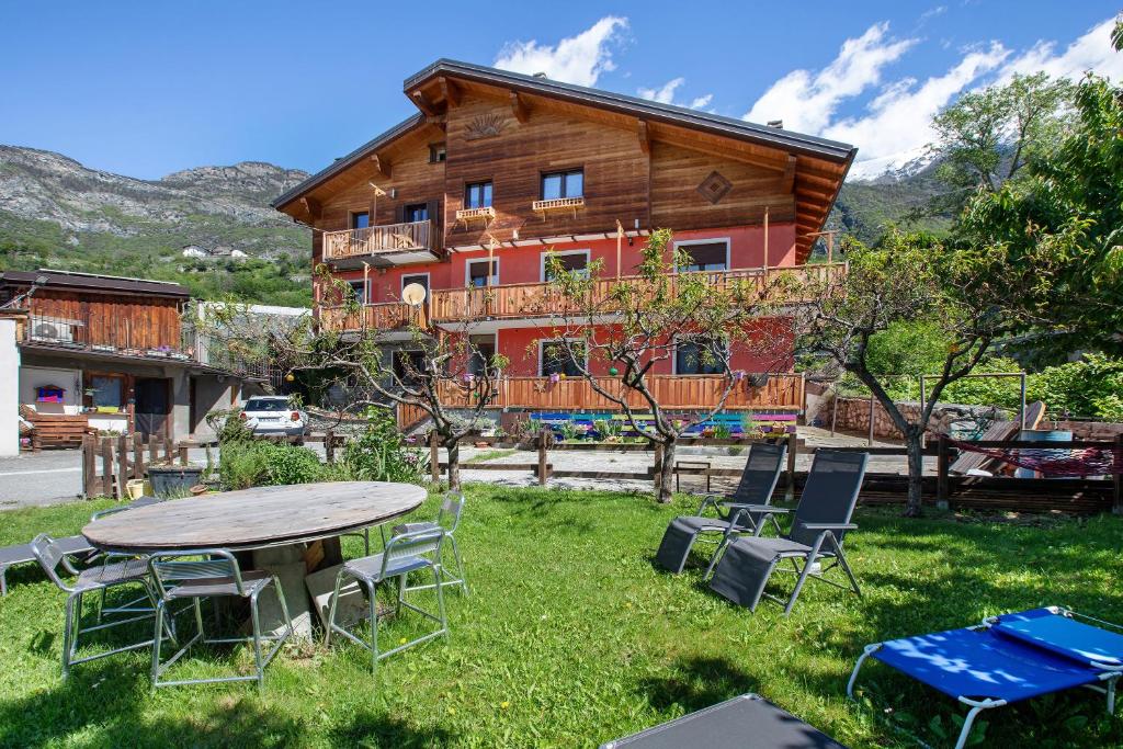 a table and chairs in front of a log house at Casa Michod Chatillon - Nonna Genia in Châtillon