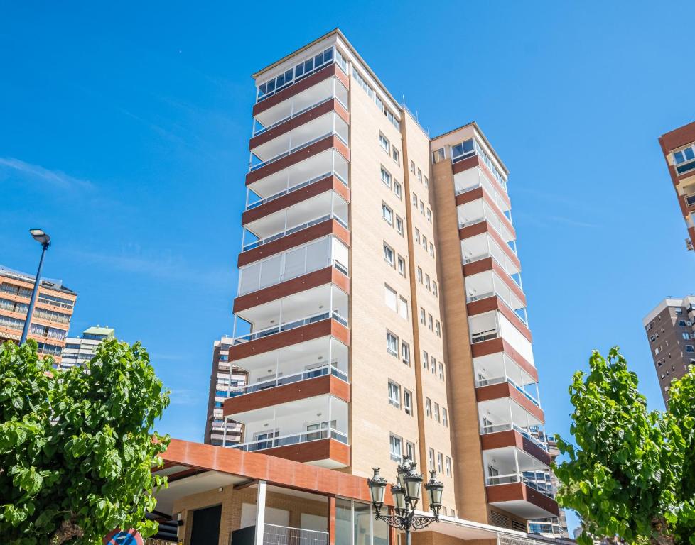 an apartment building with balconies on a city street at Apartamentos Les Dunes Centro Levante Beach in Benidorm
