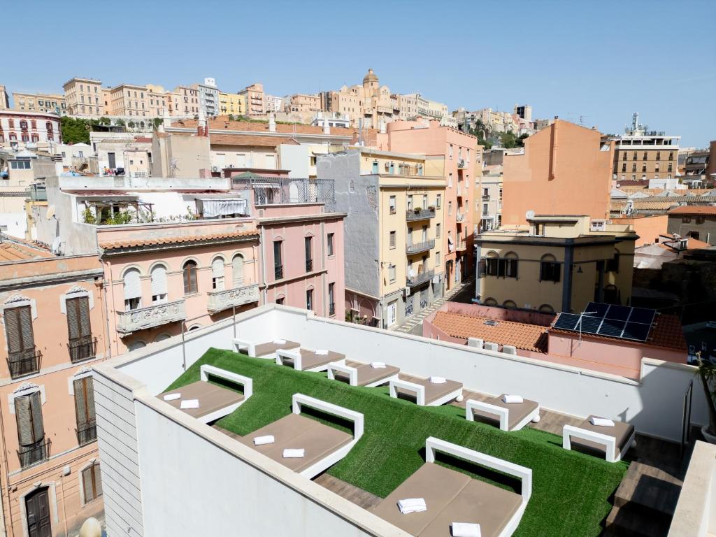 a view from the roof of a building with a green lawn at Neko Boutique Hotel in Cagliari