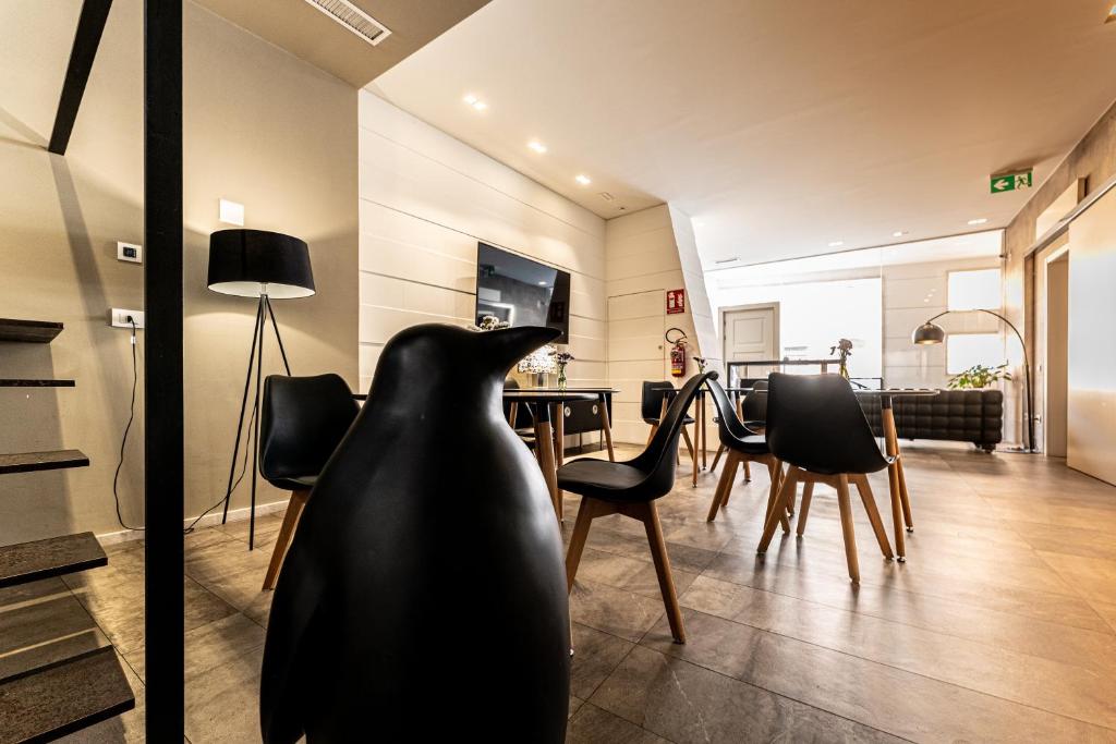 a living room with a black vase on the floor at Neko Boutique Hotel in Cagliari
