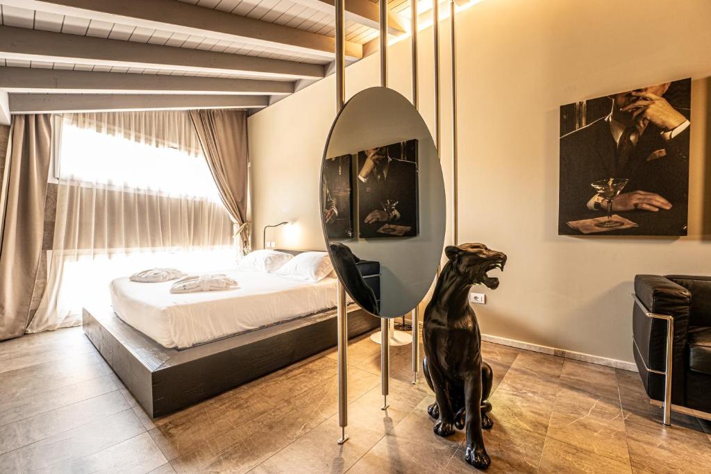 a bedroom with a dog statue in front of a bed at Neko Boutique Hotel in Cagliari