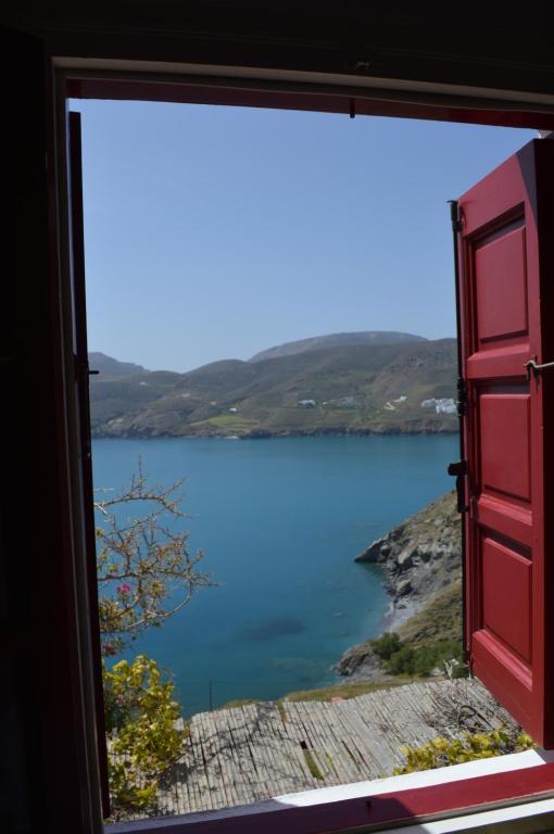 a window with a view of a body of water at The Red-Fish House in Astypalaia