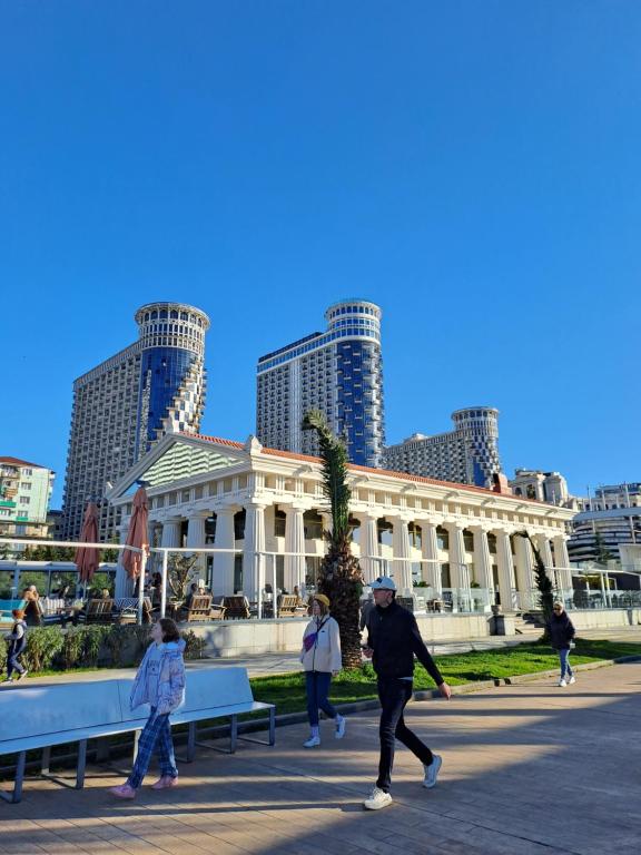 a group of people walking in front of a building at BATUMi WELLCOME ORBI APART HOTEL in Angisa