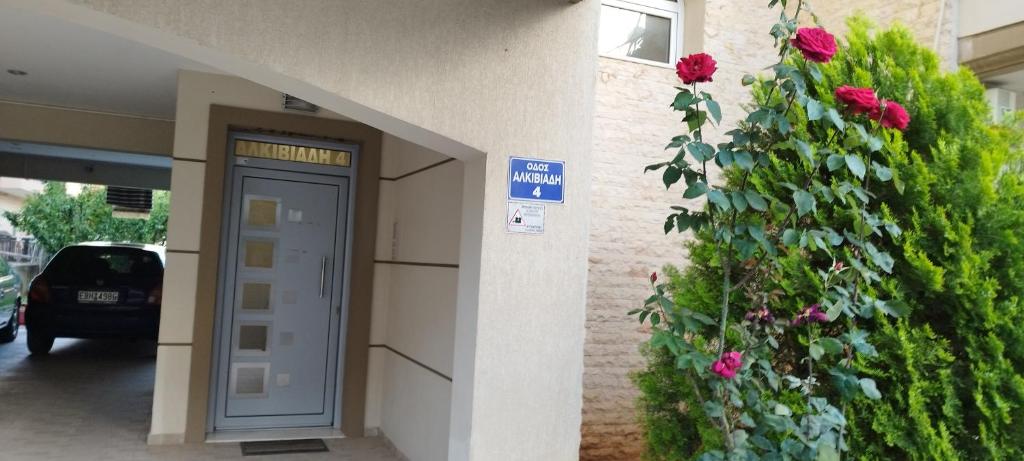 a building with a door and a rose bush at MV LUX Apartment in Alexandroupoli