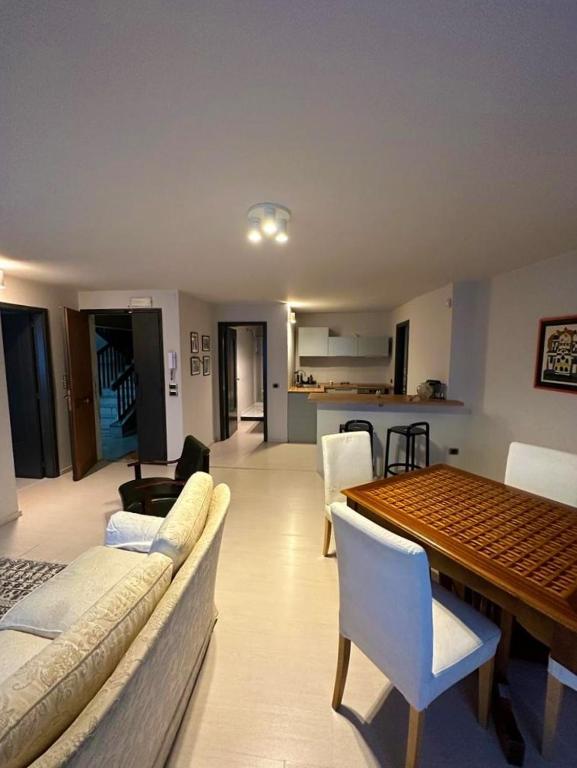 a living room with a couch and a table with chairs at Casetta in Andria