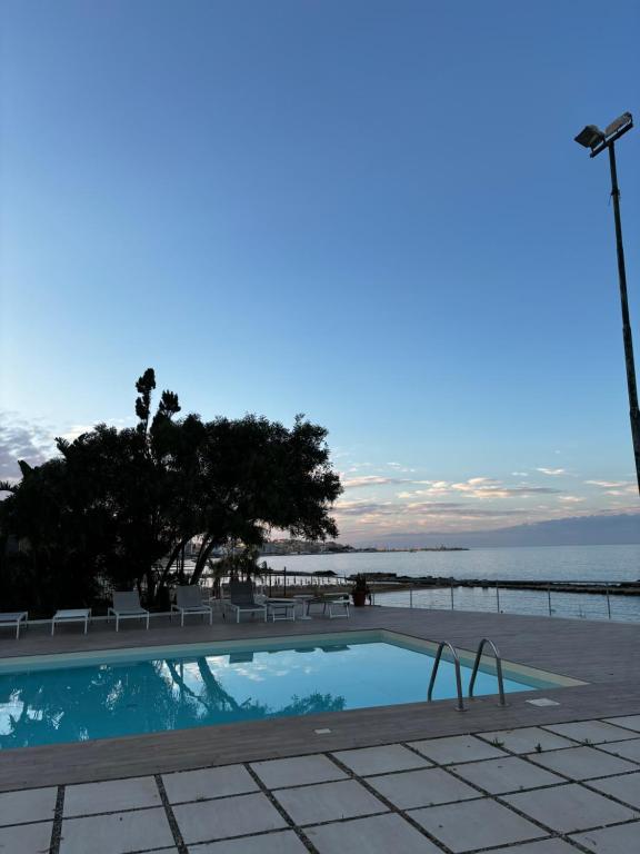 a swimming pool with a view of the ocean at B&B Do'mmilio in Crotone