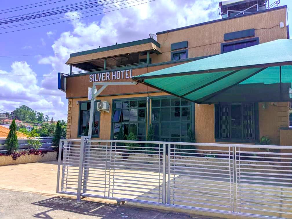 a silver hotel with a fence in front of it at SILVER HOTEL APARTMENT Near Kigali Convention Center 10 minutes in Kigali