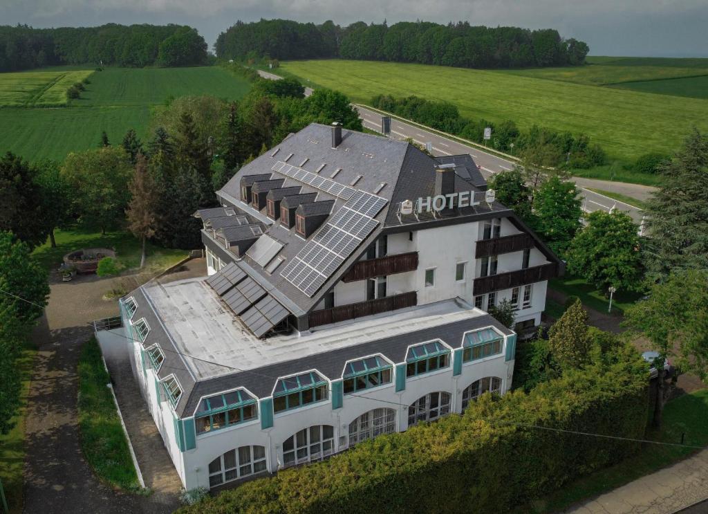 an aerial view of a building with solar panels on it at Zenner's Landhotel in Newel