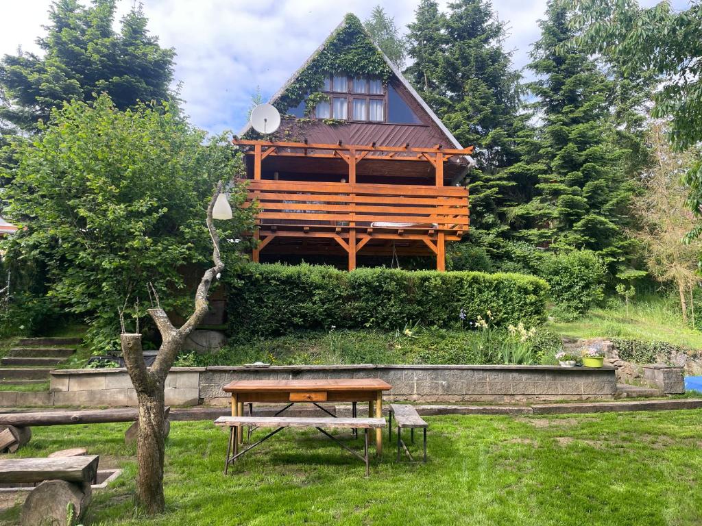 a wooden house with a picnic table in a yard at Chata Dagmar in Třebíč