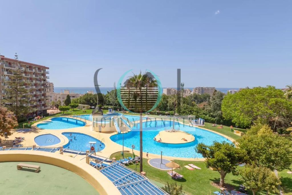 a large swimming pool with a water park at Minerva NeW in Benalmádena