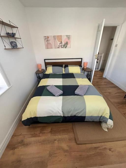 a bedroom with a bed with pillows on it at Cute 1 bed flat in Southwold in Southwold