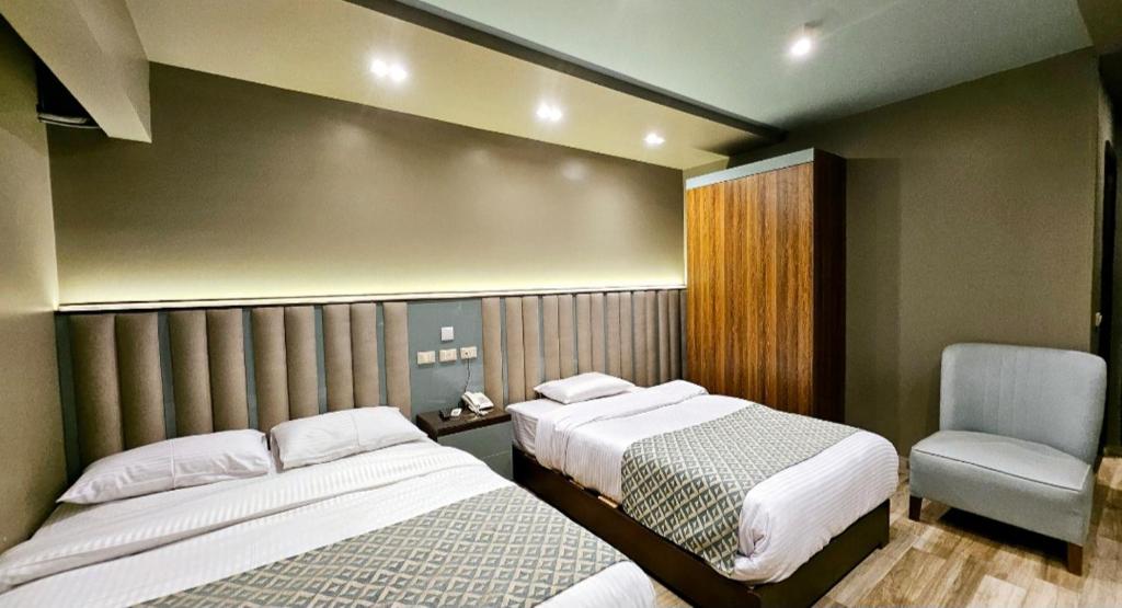 Postel nebo postele na pokoji v ubytování Grand Bayan Hotel & Apt at Nile Plaza