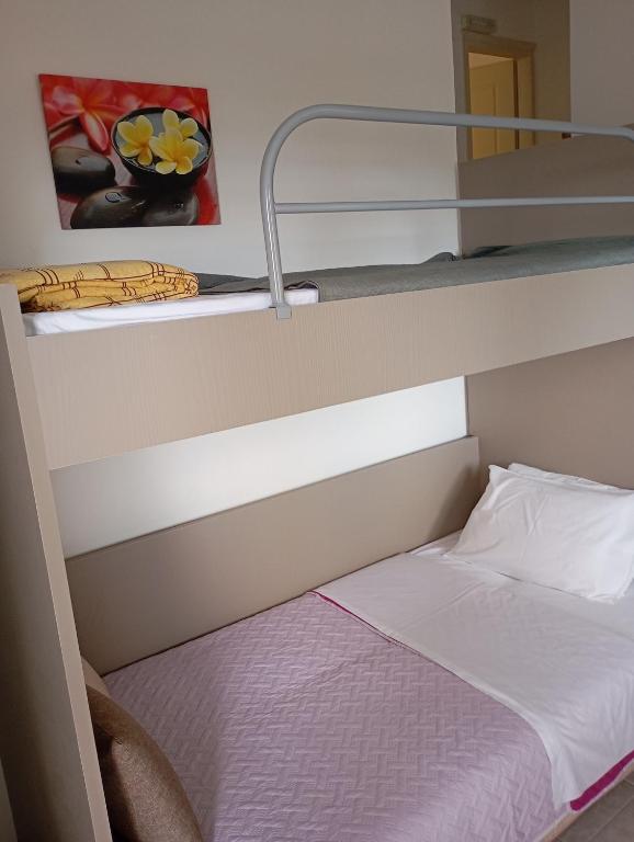 a bunk bed in a bunk bed room with a bunk bedsheet at Charoula's Apartments in Syvota